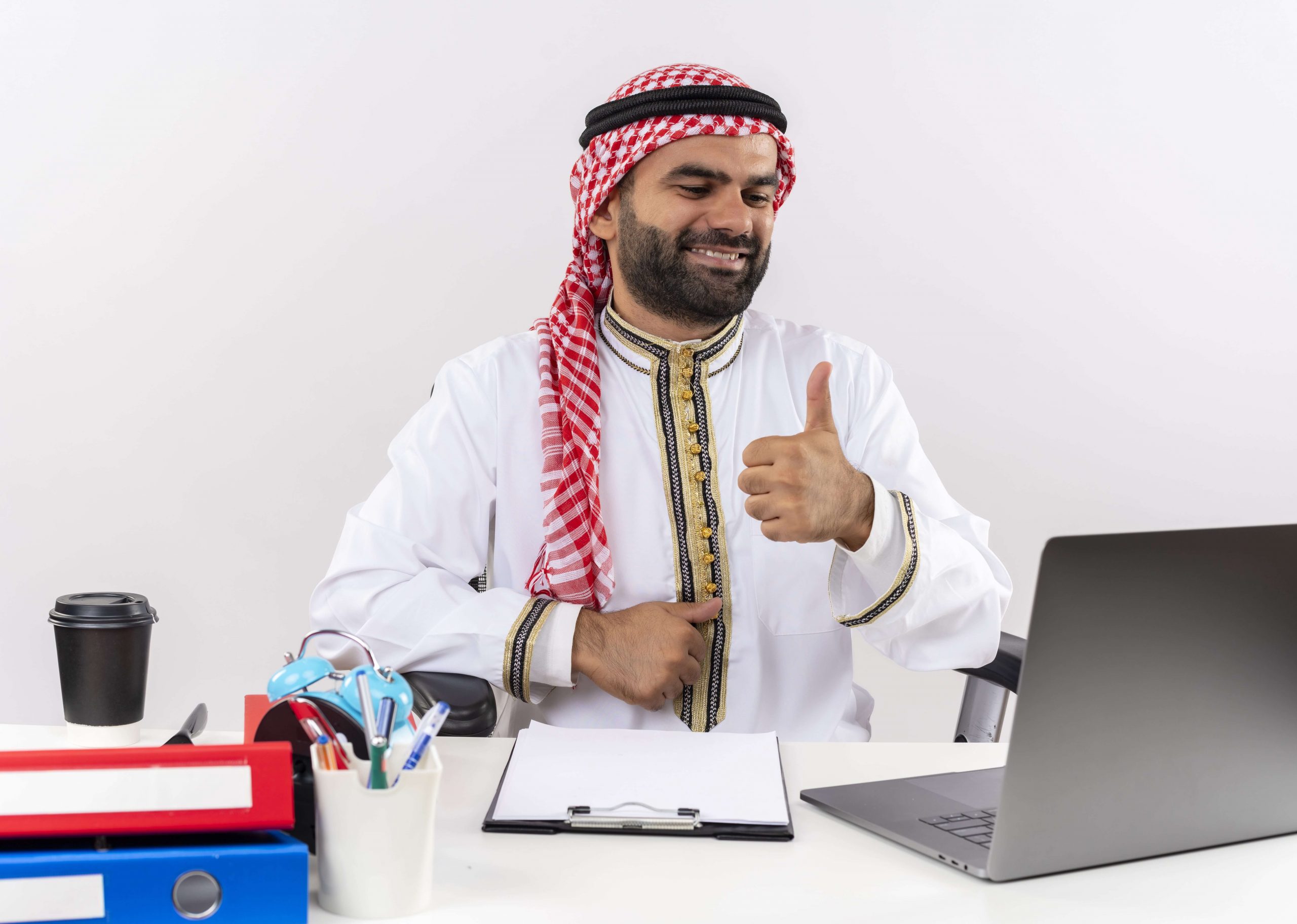 arabic-businessman-traditional-wear-sitting-table-with-laptop-computer-happy-positive-smiling-showing-thumbs-up-working-office-min (1)